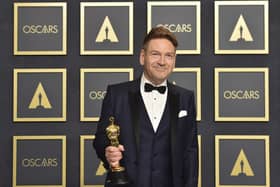 Kenneth Branagh, winner of the award for best original screenplay for "Belfast," poses in the press room at the Oscars.