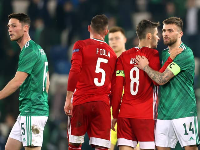 Northern Ireland's Stuart Dallas (right) and Hungary's Adam Nagy shake hands after the final whistle during the international friendly match at Windsor Park, Belfast.