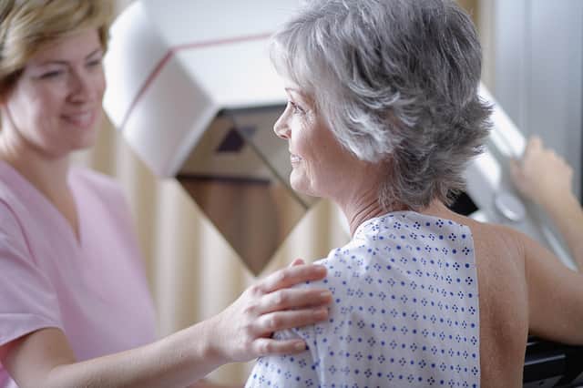 A woman undergoing a mammogram, as new figures show more than half of cancer patients in Northern Ireland wait over two months for treatment