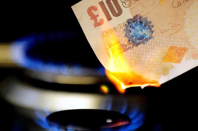 File photo dated 22/04/12 of a £10 note burning on a gas hob. Energy bill rises and increases in fuel costs. Photo credit: Rui Vieira/PA Wire