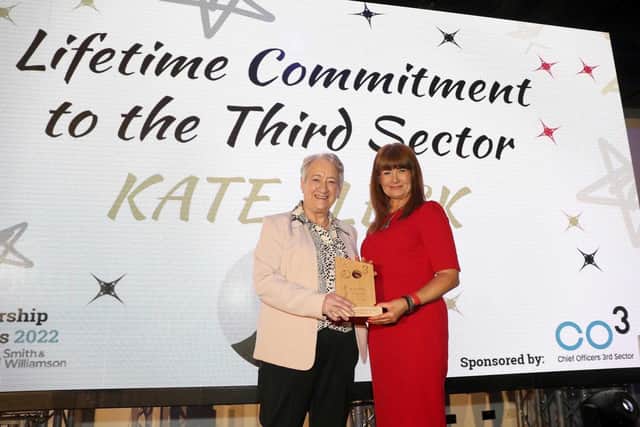 Kate Fleck pictured receiving her lifetime commitment to the third sector award from Valarie McConville, CEO of CO3, at the recent CO3 Leadership Awards 2022 held in Belfast