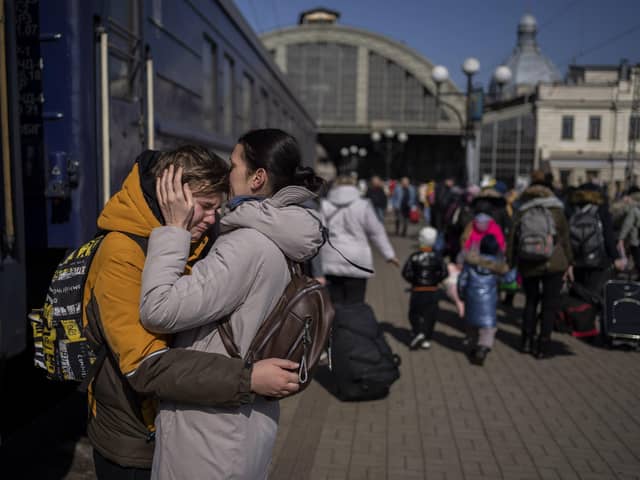A mother embraces her son who escaped the besieged city of Mariupol and arrived at the train station in Lviv, western Ukraine (AP Photo/Bernat Armangue)