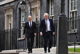 Germany's Chancellor Olaf Scholz (L) and Britain's Prime Minister Boris Johnson (R) make their way down Downing Street on Friday April 8, 2022. The UK PM did not rule out triggering Article 16 of the Northern Ireland Protocol