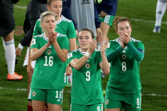 Northern Ireland’s Simone Magill (centre), Nadene Caldwell (left) and Rebecca Holloway applaud the fans at full time after the Women’s FIFA World Cup Qualifying match against England  at Windsor Park last night.