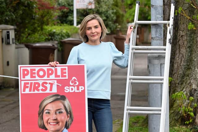 SDLP Candidate Elsie Trainor pictured as she puts up her electoral posters on the Ravenhill road in Belfast.
 Credit Presseye/Stephen Hamilton