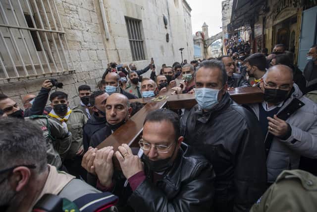 On Good Friday last year Christians carry a cross on Jerusalem’s Via Dolorosa to the Church of the Holy Sepulchre, which they believe the site of Jesus’s crucifixion. But Colin Nevin says the day cannot be proven (AP Photo/Ariel Schalit)