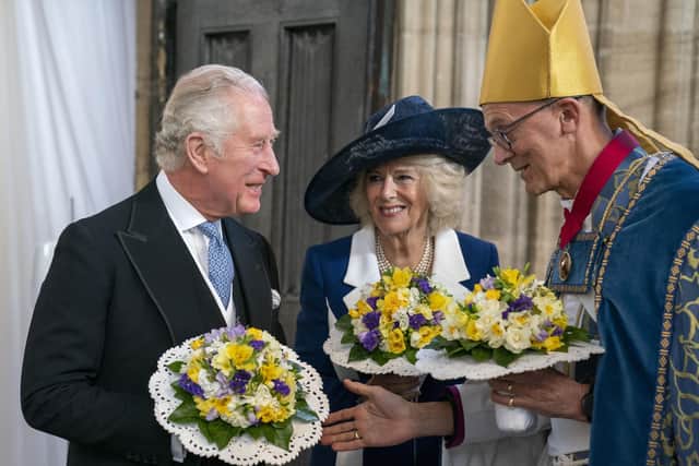 The Prince of Wales and the Duchess of Cornwall are greeted by the Dean of Windsor David Conner.