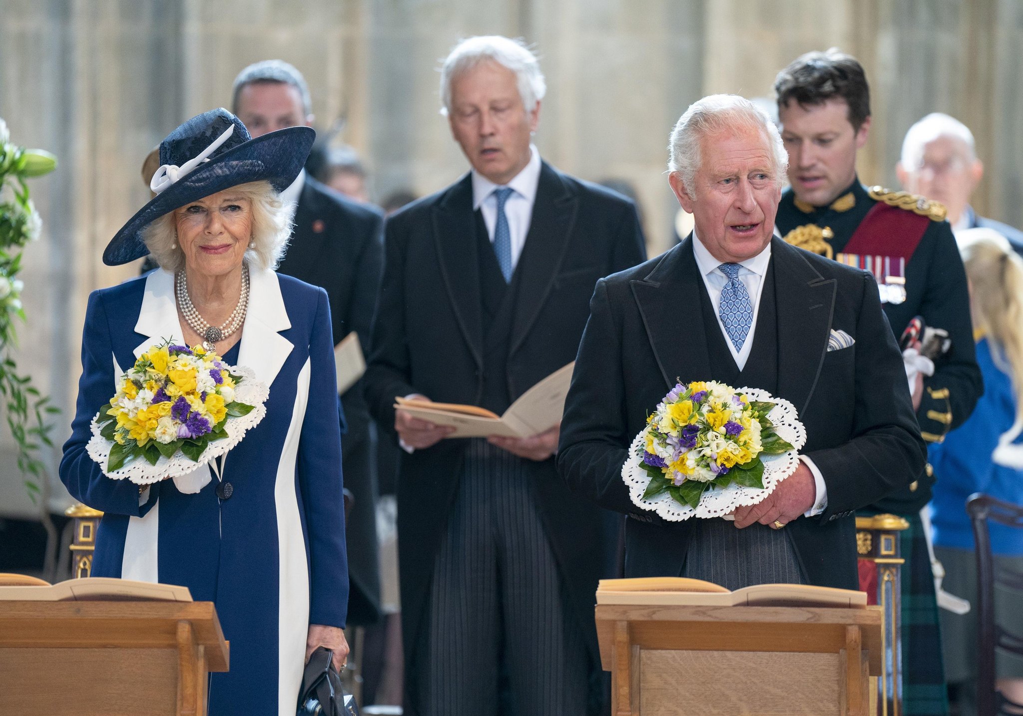 Charles gives out Maundy money at St George's Chapel in absence of Queen