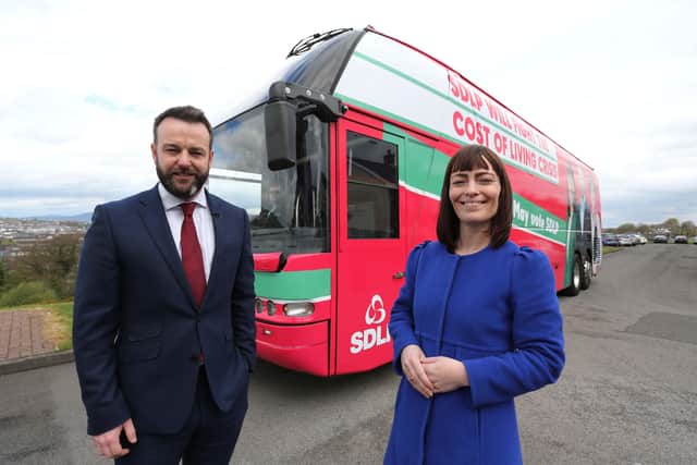 SDLP leader Colum Eastwood and deputy leader Nichola Mallon with the party's 'battle bus'
