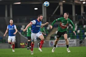 Linfield's Jamie Mulgrew and Glentoran's Seanan Clucas battle it out. Pic Colm Lenaghan/Pacemaker