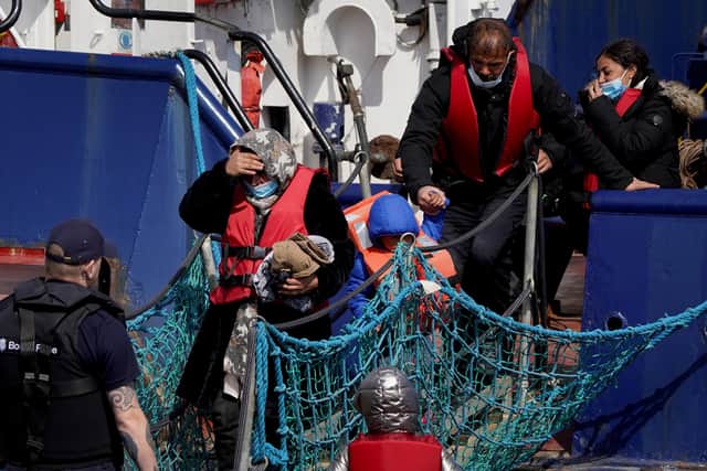 A group of people thought to be migrants are brought in to Dover, Kent, following a small boat incident in the Channel on April 19, 2022.
