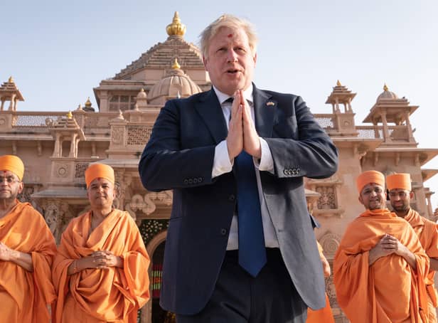 Shoeless Prime Minister Boris Johnson walks with sadhus, Hindu holymen, as he visits the Swaminarayan Akshardham temple in Gandhinagar, Ahmedabad, as part of his two day trip to India. Picture date: Thursday April 21, 2022.
