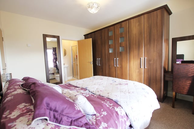 The master bedroom has attractive built-in wardrobes, vanity desk and en suite with shower, wash hand basin and toilet