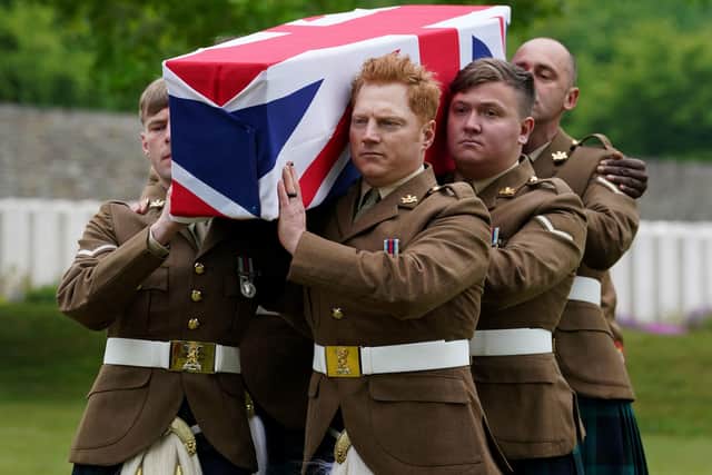A bearer party from the Royal Regiment of Scotland carry the coffin of Private William Johnston, 7th Battalion, Royal Scots Fusiliers as he is buried with full military honours at the Commonwealth War Graves Commission's (CWGC) Loos British Cemetery, Loos-en-Gohelle, France.