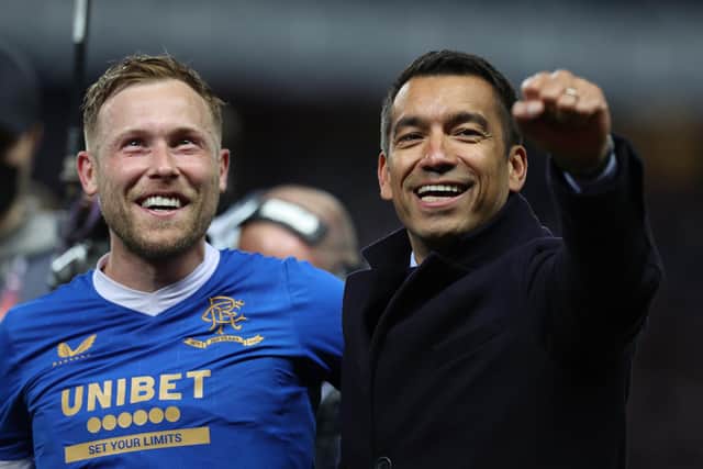 Scott Arfield of Rangers and Giovanni van Bronckhorst, Manager of Rangers celebrate after victory in the UEFA Europa League Semi Final Leg Two match between Rangers and RB Leipzig at Ibrox Stadium