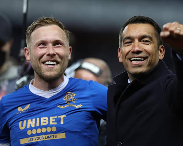 Scott Arfield of Rangers and Giovanni van Bronckhorst, Manager of Rangers celebrate after victory in the UEFA Europa League Semi Final Leg Two match between Rangers and RB Leipzig at Ibrox Stadium