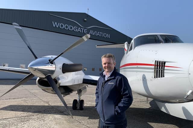 Woodgate Aviation’s head of training, Captain Simon Atkins, beside the Northern Ireland Air Ambulance at the company’s purpose-built hangar