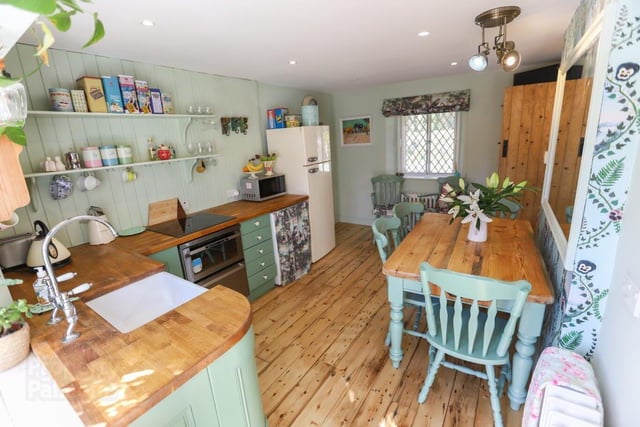 The kitchen and dining area is beautifully decorated in cottage style.