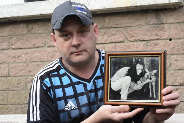 Gary Murray pictured with a photo of his 13-year-old sister Leeann, who was killed in the 1993 Shankill bombing.
 Picture: Arthur Allison/Pacemaker Press