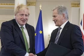 Prime Minister Boris Johnson (left) and Finland's President Sauli Niinisto, shake hands after signing a security assurance at the Presidential Palace in Helsinki, Finland.
