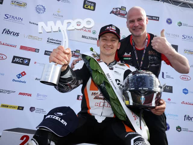 Double Supertwin race winner Richard Cooper celebrates on the podium with Ryan Farquhar.