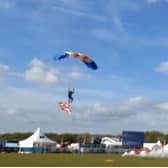 The last two of 10 members of RAF Falcons Parachute Display Team landing in the main arena at Balmoral Show, carrying flags including the Union flag, after a 7,000 foot jump which brought the four day event to a close
