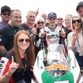 Richard Cooper celebrates his opening Supertwin race victory at the North West 200 on Saturday with the J McC Roofing team plus Ryan Farquhar and wife Karen (right).