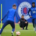 Rangers' Dutch manager Giovanni van Bronckhorst (C) watches Rangers' Welsh midfielder Aaron Ramsey (L) and Rangers' Nigerian midfielder Joseph Ayodele-Aribo at a team training session at the Rangers Training Centre in Glasgow ahead of their Europa League final football match against Eintracht Frankfurt on May 18th. Photo by ANDY BUCHANAN/AFP via Getty Images