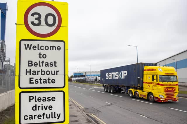 Haulage lorry drives passed a sign at Belfast Port welcoming travellers to the Harbour Estate.