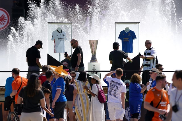 Rangers and Eintracht Frankfurt fans get their photo taken with the the Europa League trophy in the Plaza de Espana before the UEFA Europa League Final at the Estadio Ramon Sanchez-Pizjuan, Seville.