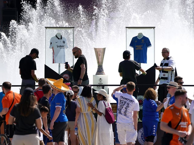 Rangers and Eintracht Frankfurt fans get their photo taken with the the Europa League trophy in the Plaza de Espana before the UEFA Europa League Final at the Estadio Ramon Sanchez-Pizjuan, Seville.