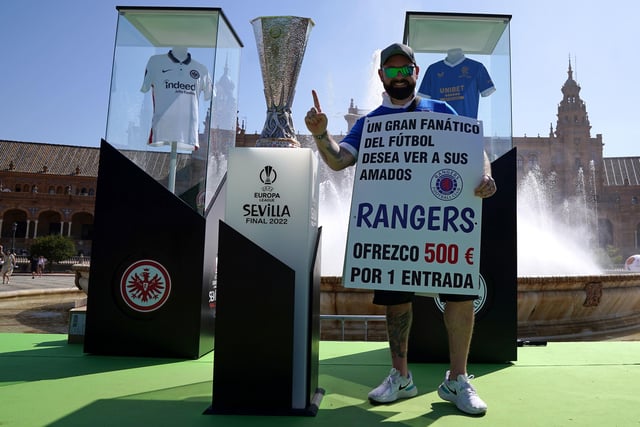 Rangers fan Andrew Jordan with the the Europa League trophy as they ask for tickets in the Plaza de Espana before the UEFA Europa League Final at the Estadio Ramon Sanchez-Pizjuan, Seville.