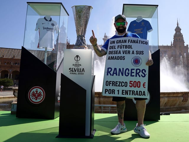 Rangers fan Andrew Jordan with the the Europa League trophy as they ask for tickets in the Plaza de Espana before the UEFA Europa League Final at the Estadio Ramon Sanchez-Pizjuan, Seville.