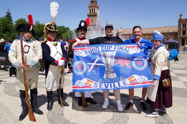 Rangers fans pose with locals in old military outfitts in the Plaza de Espana before the UEFA Europa League Final at the Estadio Ramon Sanchez-Pizjuan, Seville.