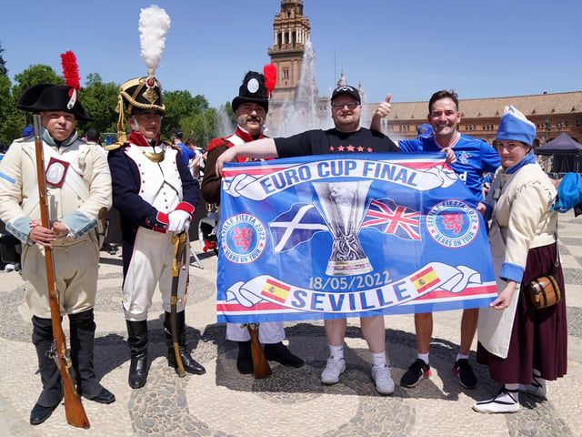 Rangers fans pose with locals in old military outfitts in the Plaza de Espana before the UEFA Europa League Final at the Estadio Ramon Sanchez-Pizjuan, Seville.