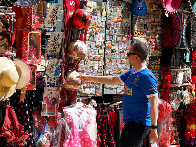 Rangers fan looks at the local merchandise in the Plaza de Espana before the UEFA Europa League Final at the Estadio Ramon Sanchez-Pizjuan, Seville.