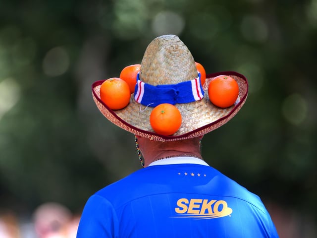 A Rangers fan wears a hat decorated with oranges at the Alameda de Hercules ahead of the UEFA Europa League Final at the Estadio Ramon Sanchez-Pizjuan, Seville.