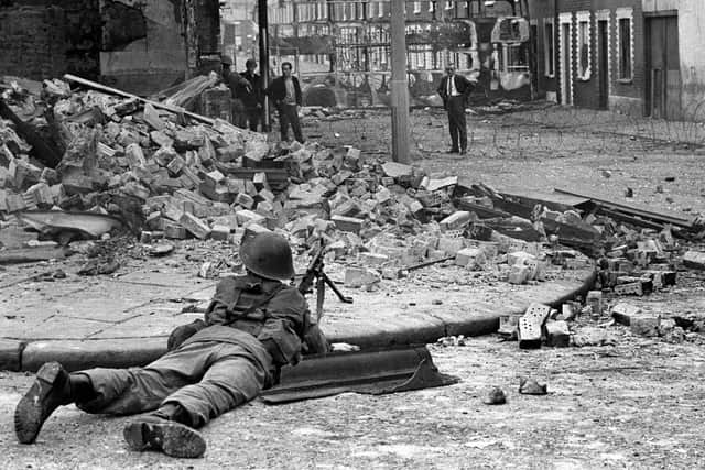 A British Army soldier on lookout in the Falls Road area of Belfast in August 1969