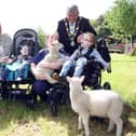 Jack McCrystal (13) from Draperstown, Theo Walker (4) from Belfast and James McKinney (5) from Belfast joined Mayor of Antrim and Newtownabbey, Councillor Billy Webb, NI Hospice Chief Executive, Heather Weir and Nurse Louise Devlin celebrated the honour with the lambs.