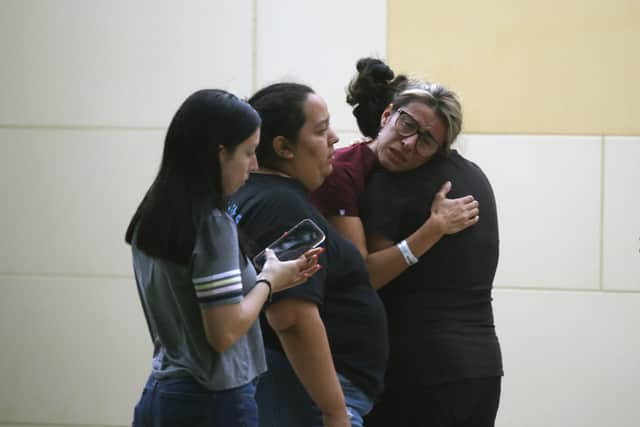 People react outside the Civic Center following a deadly school shooting at Robb Elementary School in Uvalde, Texas Tuesday, May 24, 2022. (AP Photo/Dario Lopez-Mills)