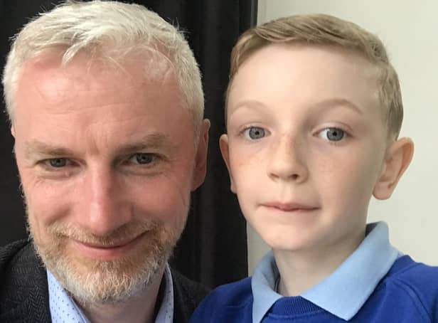 Father and son with (very) shorn locks