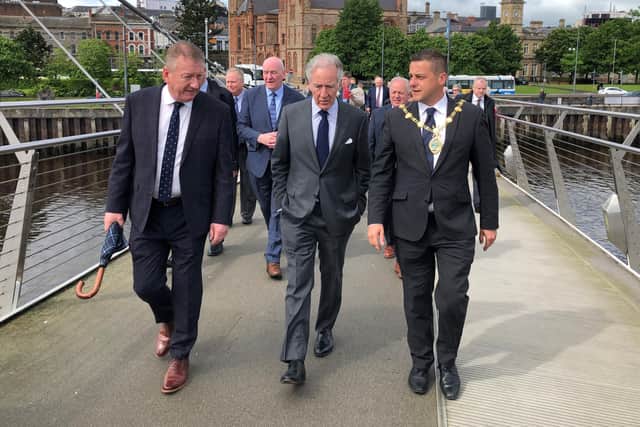 Richard Neal (centre) with Mayor of Derry City and Strabane Graham Warke (right), and Derry city centre manager Jim Roddy, walking across the Peace Bridge in Londonderry yesterday