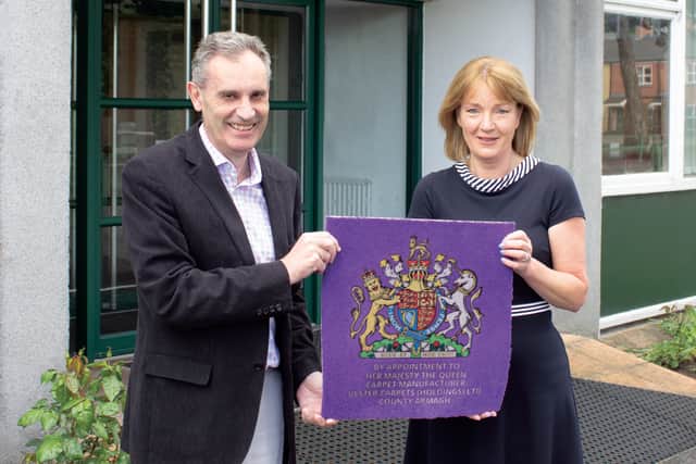 Nick Coburn CBE, group managing director and Joyce McIvor, Contract sales director for UK and Ireland, mark the news that Ulster Carpets have been granted a Royal Warrant by Her Majesty the Queen