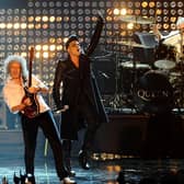 Adam Lambert(centre) performs with Brian May (left) and Roger Taylor of  Queen, during the 2011 MTV Europe Music Awards at the Odyssey Arena, Belfast. Photo: Ian West/PA Wire