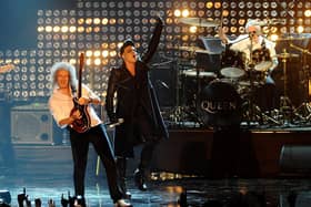 Adam Lambert(centre) performs with Brian May (left) and Roger Taylor of  Queen, during the 2011 MTV Europe Music Awards at the Odyssey Arena, Belfast. Photo: Ian West/PA Wire