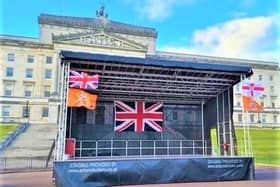 While the Union Flag will not be flying above the starting point at Stormont last night organisers had begun festooning the platform next to Parliament Buildings with red, white, blue and orange