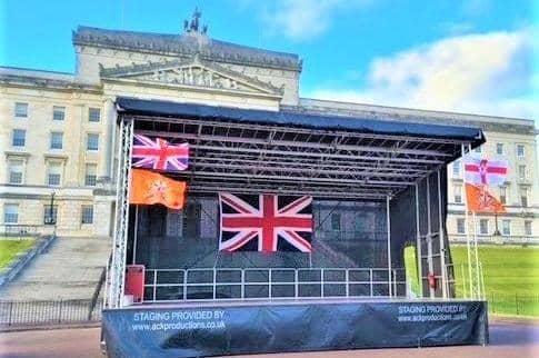 While the Union Flag will not be flying above the starting point at Stormont last night organisers had begun festooning the platform next to Parliament Buildings with red, white, blue and orange