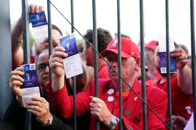 Liverpool fans stuck outside the ground show their match tickets during the UEFA Champions League final at the Stade de France, Paris. Pic by PA.