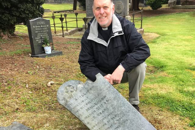 Rev Brian Moodie of Banbridge Non-Subscribing Presbyterian Church surveys the damage done by vandals to a 200 year old gravestone in the Old Meeting House Green Graveyard.