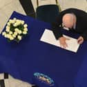 Belfast councillor Billy Hutchinson signs a book of condolences that was opened up for the victims of the Manchester Arena  bomb attack in May 2017
